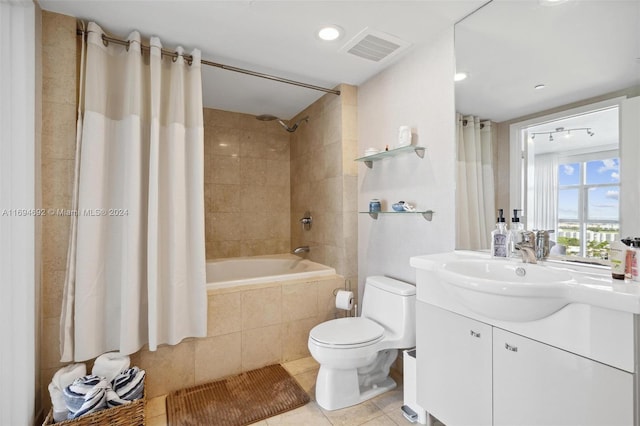 full bathroom featuring tile patterned flooring, vanity, toilet, and shower / bath combo with shower curtain