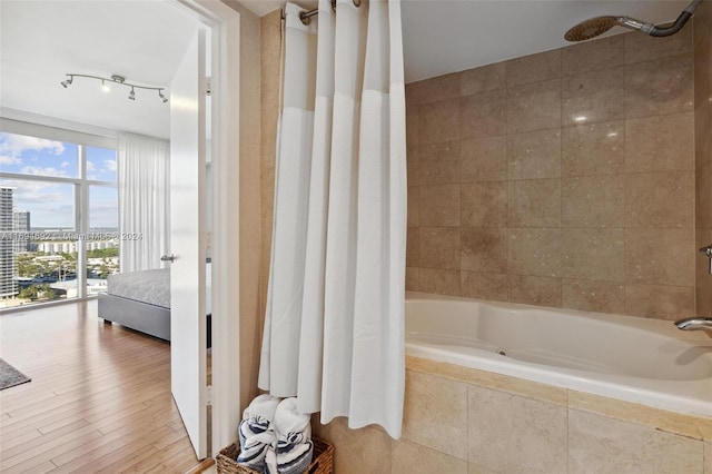 bathroom featuring shower / bath combo and hardwood / wood-style flooring