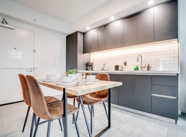 227 NE 2nd St Unit 1705, Miami, FL 33132 - kitchen with gray cabinetry, decorative backsplash, a sink, light countertops, and recessed lighting