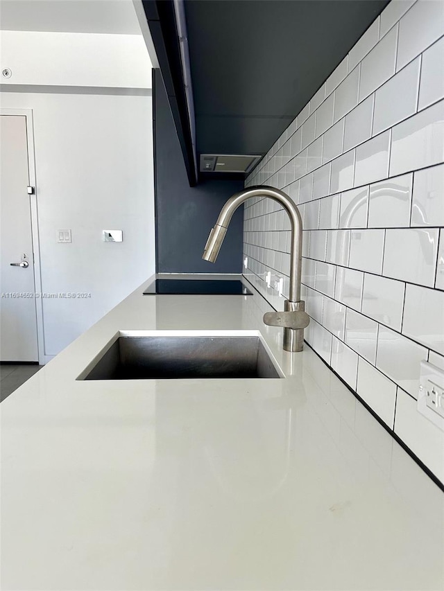 room details featuring sink and tasteful backsplash