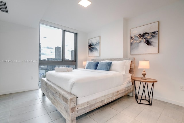 227 NE 2nd St Unit 1705, Miami, FL 33132 - bedroom with baseboards and light tile patterned floors