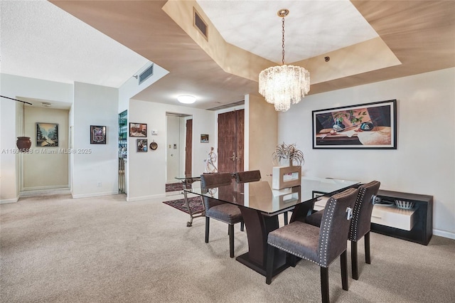 dining area with light carpet and a notable chandelier