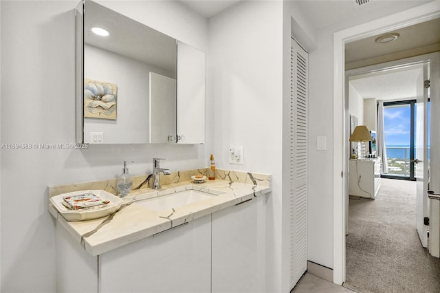 bathroom featuring vanity and expansive windows