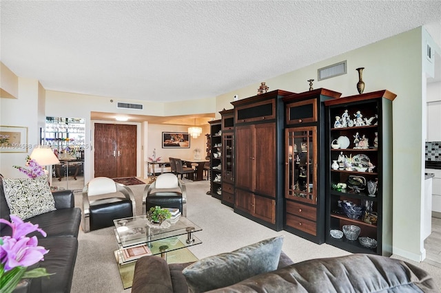 carpeted living room featuring a textured ceiling