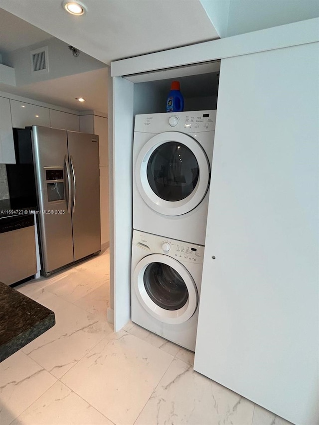 laundry area with stacked washer and dryer