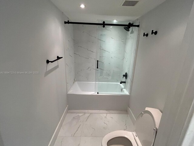 bathroom featuring toilet and tiled shower / bath