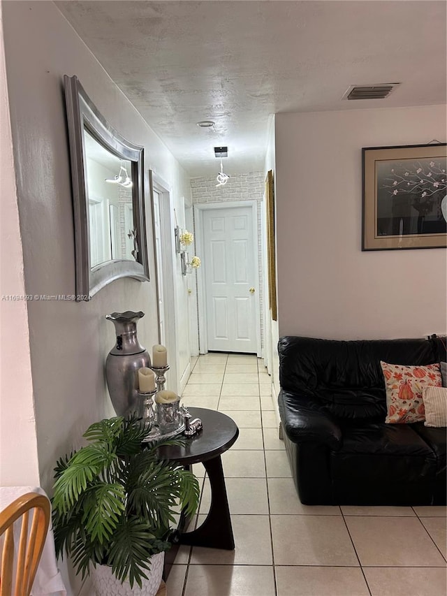 hall featuring light tile patterned flooring