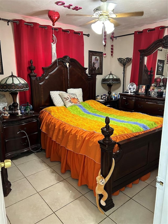 tiled bedroom featuring ceiling fan