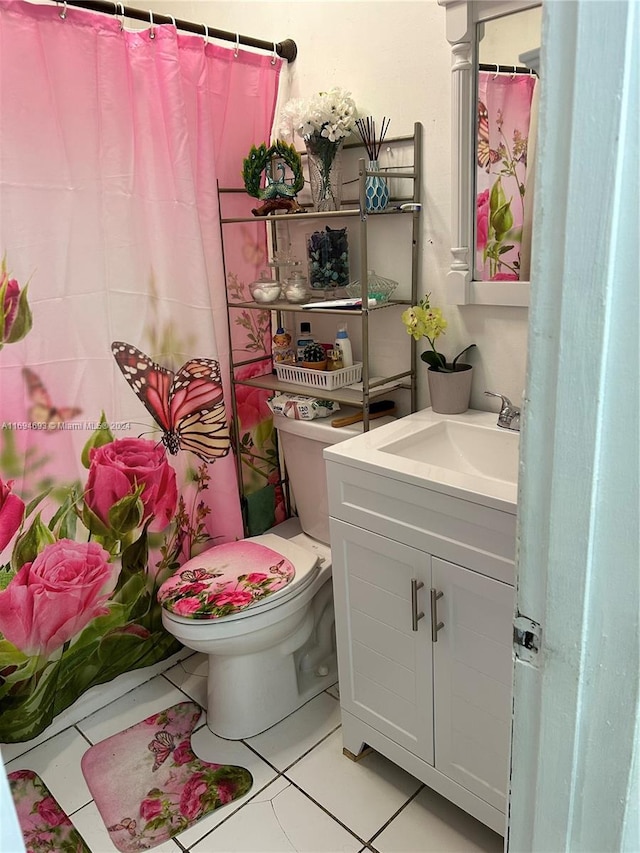 bathroom with walk in shower, tile patterned flooring, vanity, and toilet