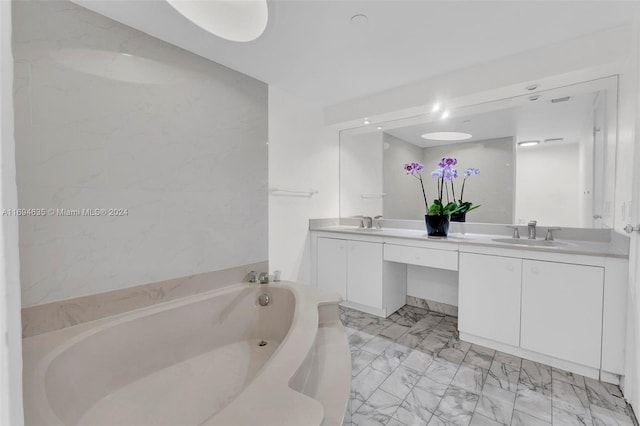 bathroom with a tub and vanity