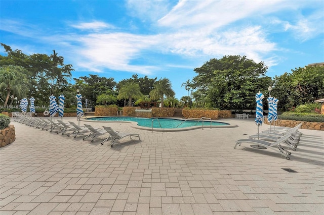 view of swimming pool featuring a patio and pool water feature