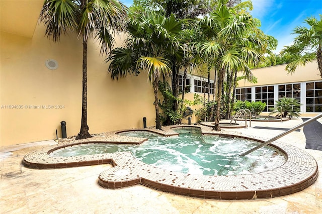 view of swimming pool featuring an in ground hot tub