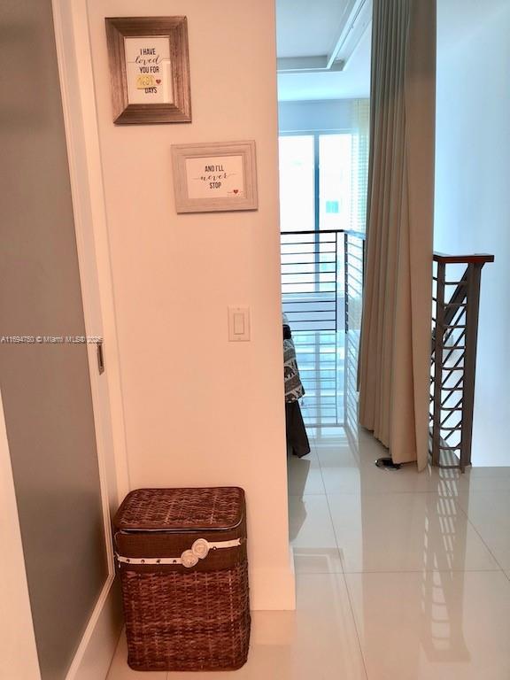 hallway featuring tile patterned flooring