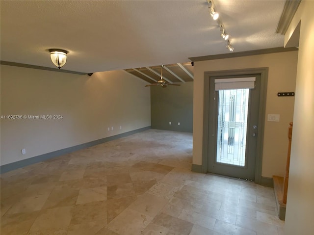 empty room featuring a textured ceiling and ceiling fan