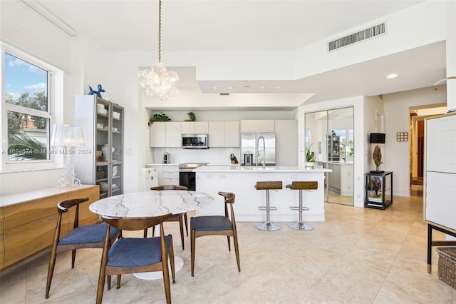 dining room featuring an inviting chandelier and sink