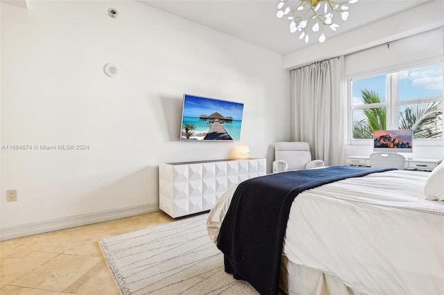 tiled bedroom with a notable chandelier