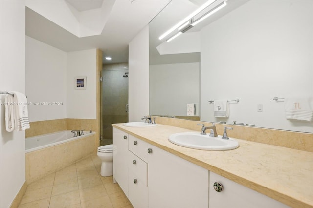 full bathroom with vanity, tile patterned floors, separate shower and tub, and toilet