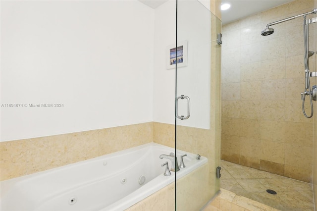 bathroom featuring tile patterned floors and separate shower and tub