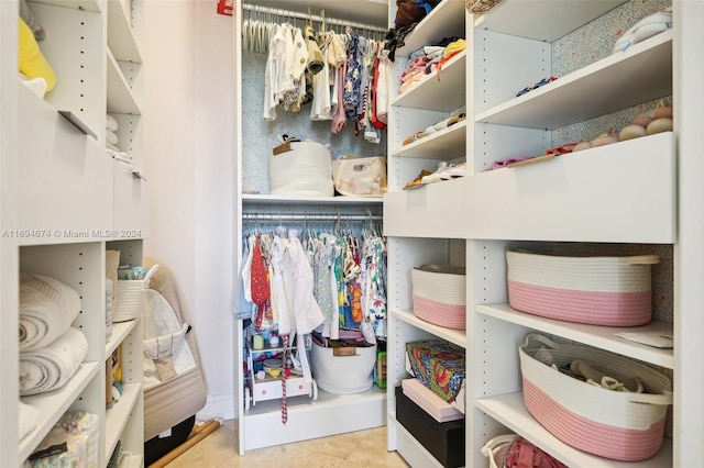 spacious closet with light tile patterned floors