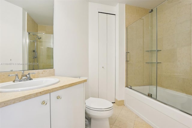 full bathroom with tile patterned flooring, vanity, toilet, and bath / shower combo with glass door