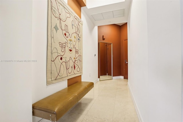 corridor with light tile patterned flooring