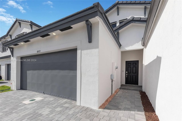 view of exterior entry featuring a garage