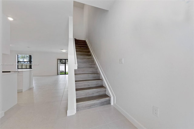 stairway featuring tile patterned floors