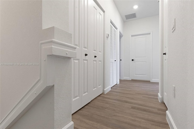 corridor with light hardwood / wood-style flooring