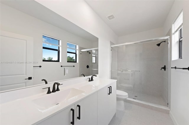 bathroom with a shower with door, vanity, and toilet