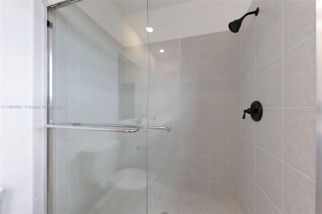 bathroom featuring a shower with shower door