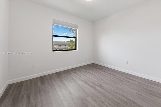 empty room with hardwood / wood-style floors