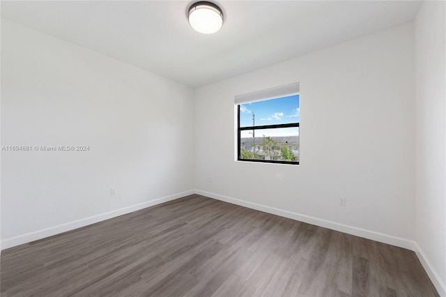 unfurnished room with hardwood / wood-style flooring