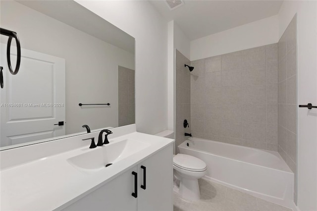 full bathroom featuring tile patterned floors, vanity, tiled shower / bath combo, and toilet