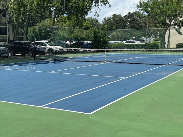 view of tennis court featuring basketball hoop