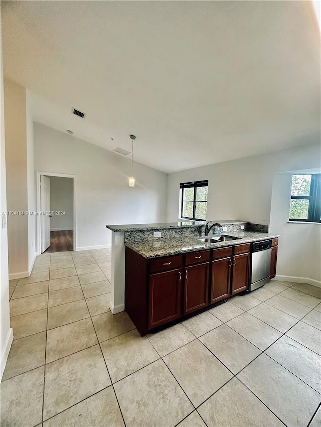 kitchen featuring light stone countertops, stainless steel dishwasher, lofted ceiling, decorative light fixtures, and light tile patterned flooring