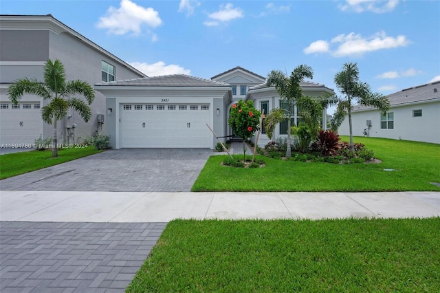 view of front of property with a garage and a front yard