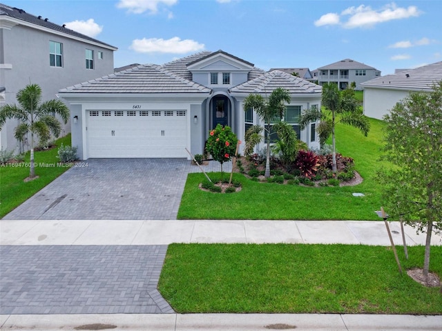 view of front facade with a front yard and a garage