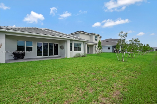 rear view of property with a yard