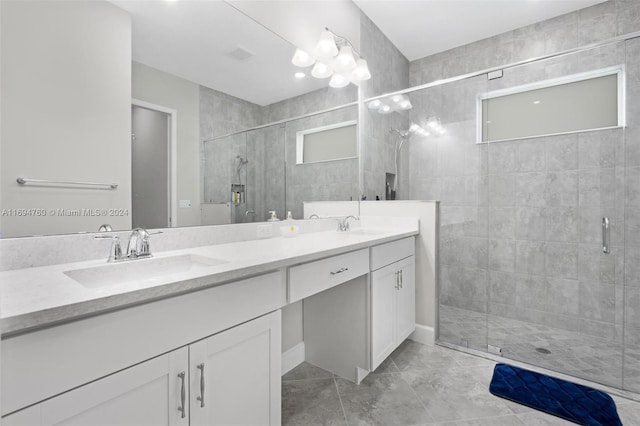 bathroom featuring tile patterned flooring, vanity, and an enclosed shower