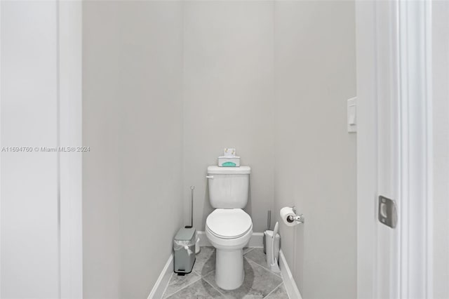 bathroom featuring tile patterned flooring and toilet