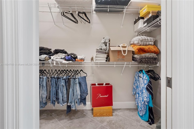 spacious closet with tile patterned floors