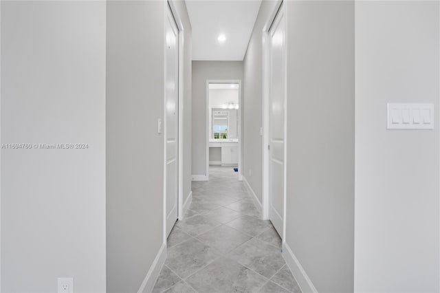 hall featuring light tile patterned flooring