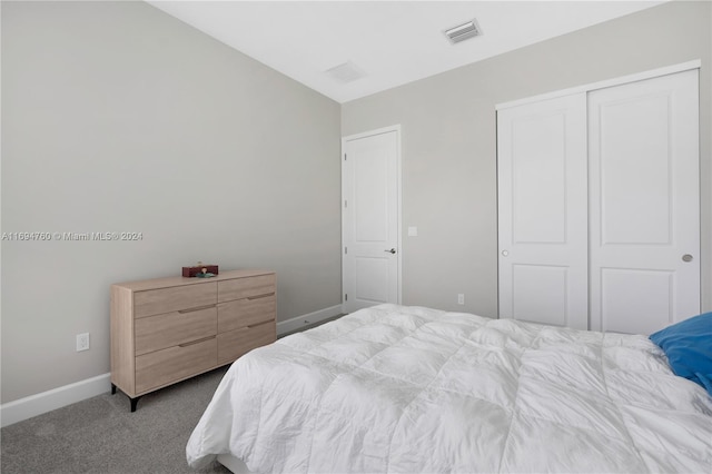 bedroom with carpet and a closet