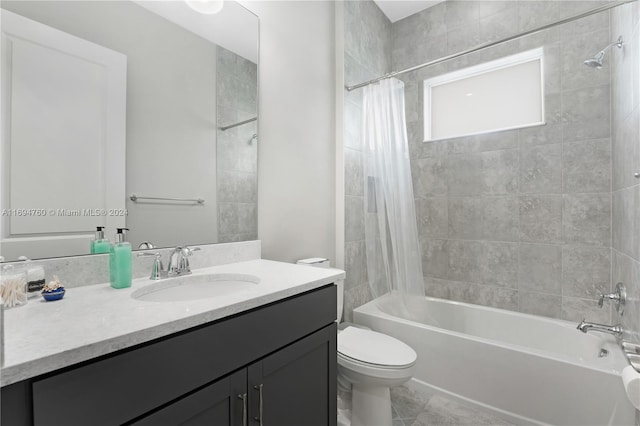 full bathroom with tile patterned floors, vanity, shower / bath combo, and toilet