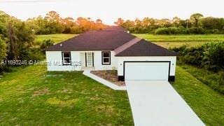 ranch-style home featuring a front yard and a garage