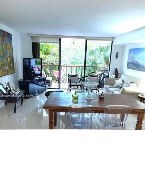 living room featuring light tile patterned flooring and a wall of windows