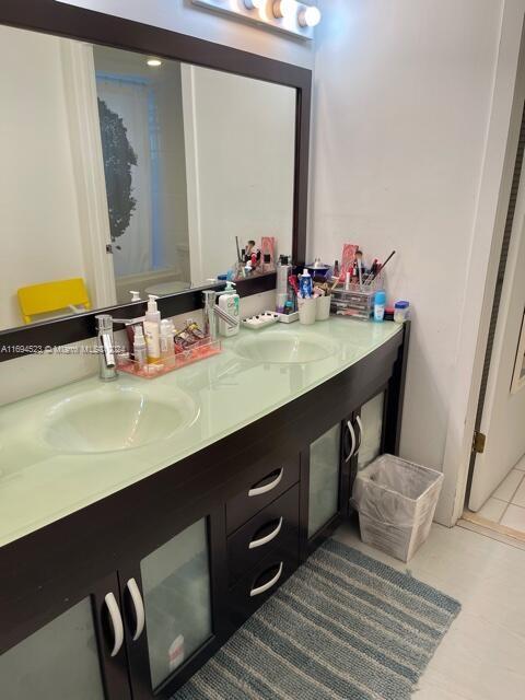 bathroom with tile patterned flooring and vanity