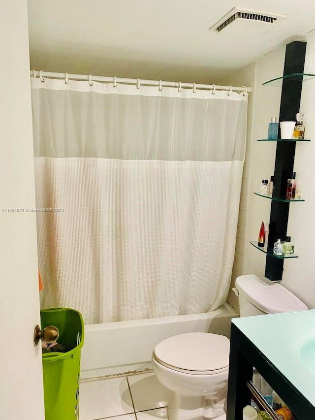 full bathroom featuring tile patterned flooring, vanity, shower / tub combo with curtain, and toilet