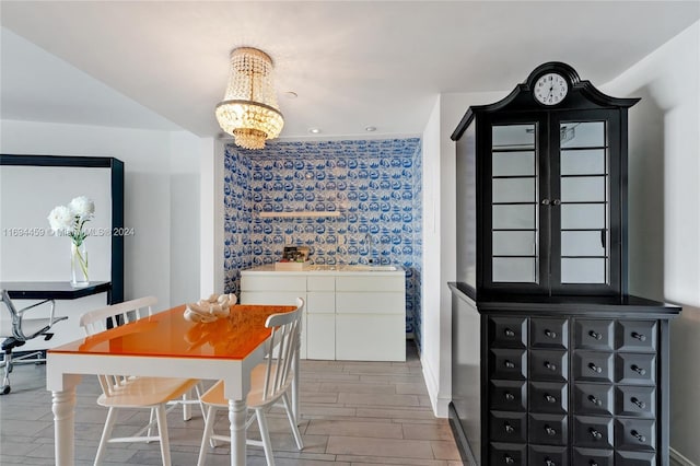 dining area with hardwood / wood-style floors, a notable chandelier, and sink