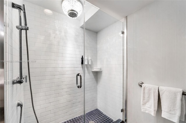 bathroom with a shower with door